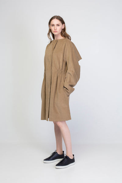 Beige corduroy transformer jacket with rectangle sleeves and gathering.