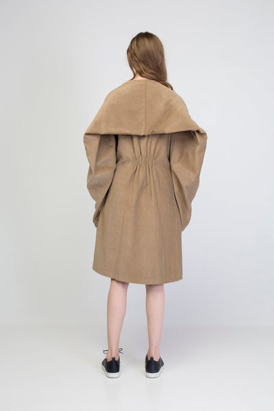 Beige corduroy transformer jacket with rectangle sleeves and gathering.