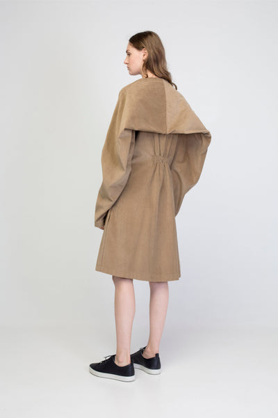 Beige corduroy transformer jacket with rectangle sleeves and gathering.