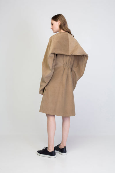 Beige corduroy transformer jacket with rectangle sleeves and gathering.