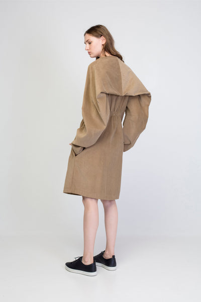 Beige corduroy transformer jacket with rectangle sleeves and gathering.